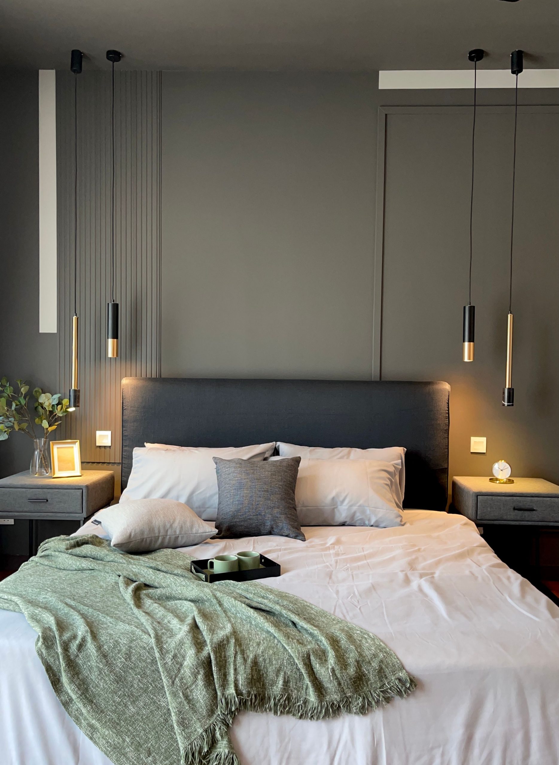 Master bedroom with pendant lights, bed and decorative items to suit the design theme.