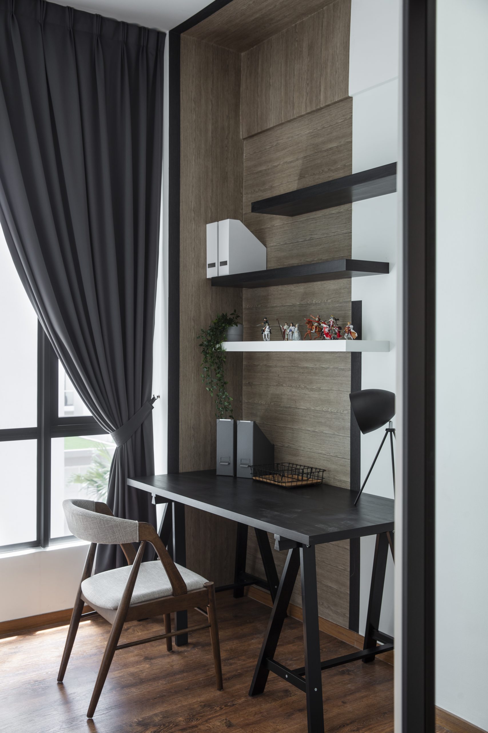 Study room designed by our Makeover Guys theme which includes wall shelves, a designer chair, and work desk.